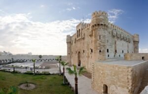 The intricate stone battlements and towers of Qaitbay Citadel in Alexandria